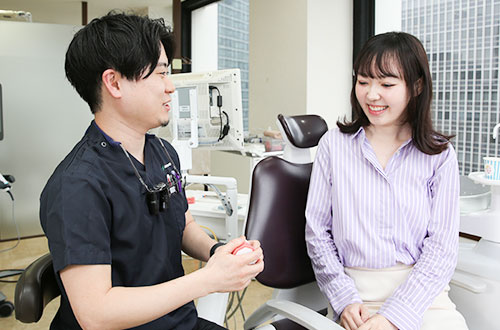 治療の説明を行う歯科医師