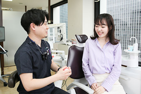 歯並びについて説明する歯科医師